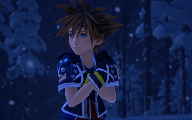 Sora from Kingdom Hearts stands in a snowy forest with a thoughtful expression
