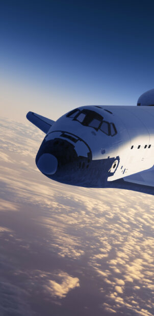 A space shuttle flying above clouds during sunset showcasing advanced aerospace technology