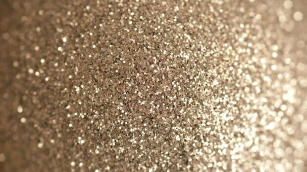 Shimmering sparkle texture with a golden glitter pattern in close up view