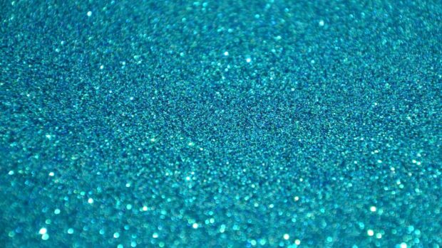 Close up of blue sparkle texture with glitter particles in high definition