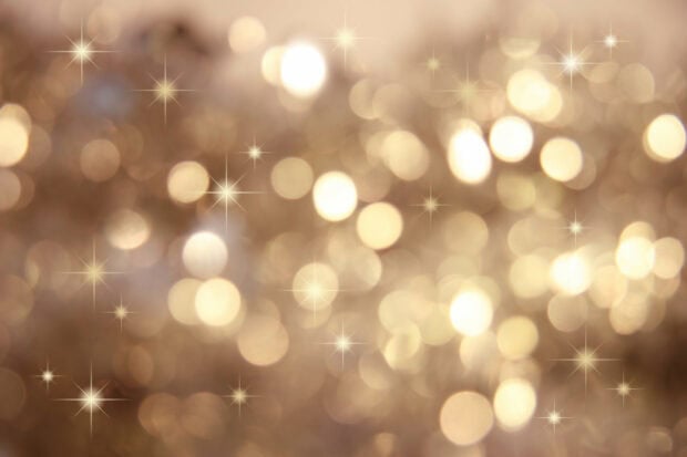 Soft golden bokeh glitter with sparkle effects in a festive pattern