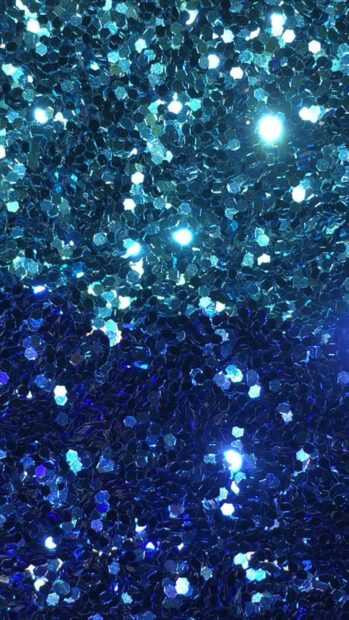 Blue sparkle texture with shining glitter reflecting light in high detail