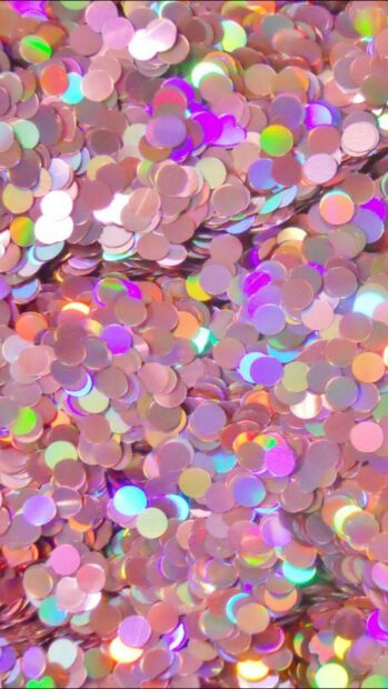 Shiny sparkle with colorful round confetti in vibrant hues on a pink background