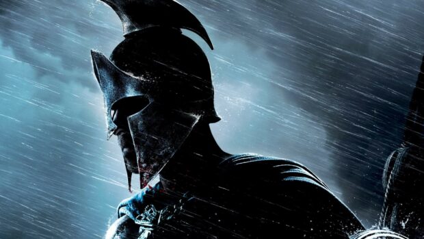 Spartan warrior wearing a battle helmet in the rain with a focused expression