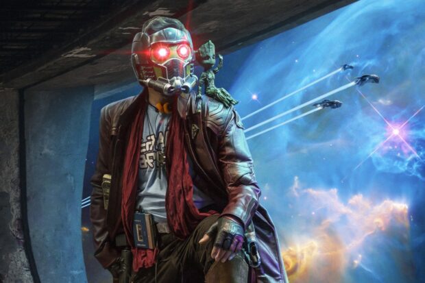 Star Lord wearing his iconic helmet with glowing red eyes and Groot on his shoulder in space scene