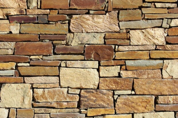 A detailed stone wall with various textured stones forming a strong structure