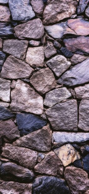 Close up of natural stone wall showing detailed texture and rough surface