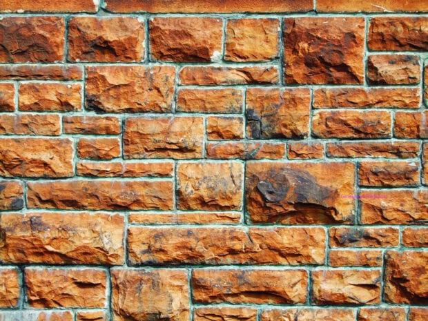Close up of stone wall with rough texture and natural stone pattern