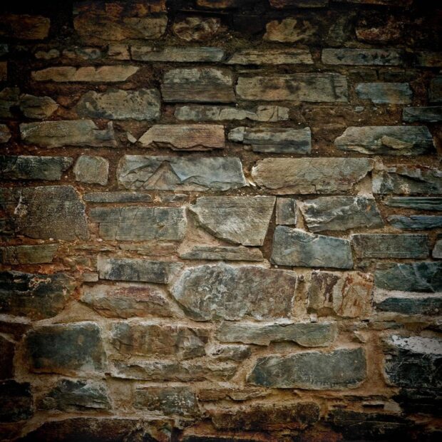 Rustic stone wall texture showcasing natural stone structure and rough surfaces