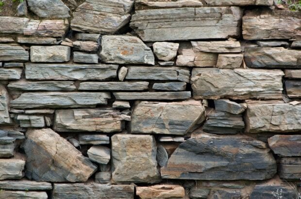 A close up view of natural stone wall with varied shapes and textures