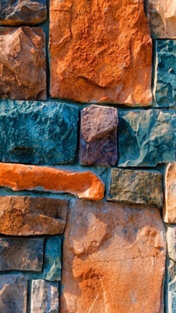 Colorful stone wall showing various textures and shapes in a close up view