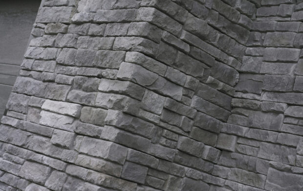 Close up of textured rough stone wall showcasing natural stone pattern