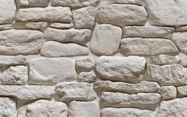 White rough stone texture forming a natural stone wall pattern