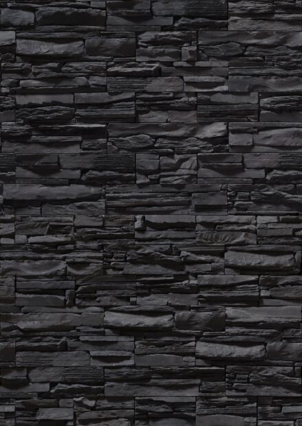 Dark textured stone wall with rough surface and natural pattern