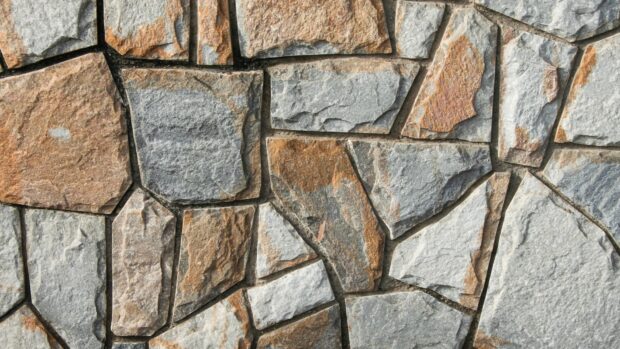 A textured stone surface with various shapes and natural patterns of stone
