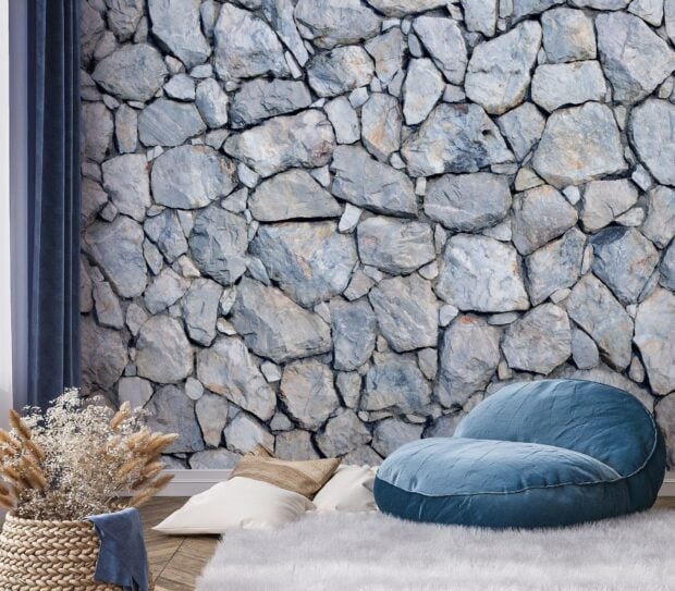 A cozy room with stone wall texture featuring natural stone patterns and a comfortable chair