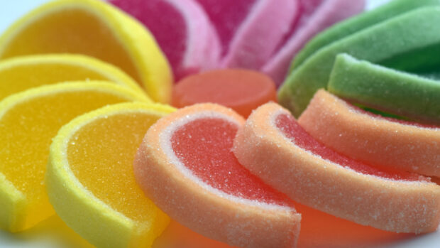 Colorful sugar candy slices arranged in a close up view with bright colors and sugar crystals