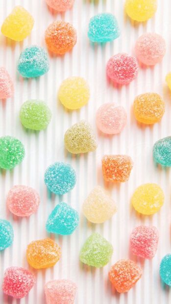 Colorful sugar candies arranged neatly on a white surface