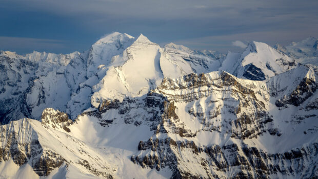Snow covered peaks in Switzerland mountain range under a clear sky