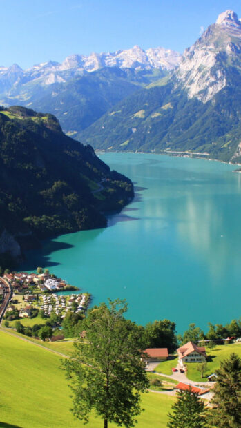 Scenic Switzerland landscape with turquoise lake and green hills under clear sky