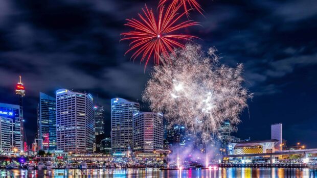 Sydney cityscape with fireworks lighting up the night sky over the water