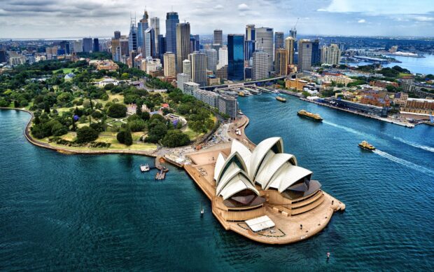 Aerial view of Sydney city with iconic opera house and harbor landmarks in clear daylight