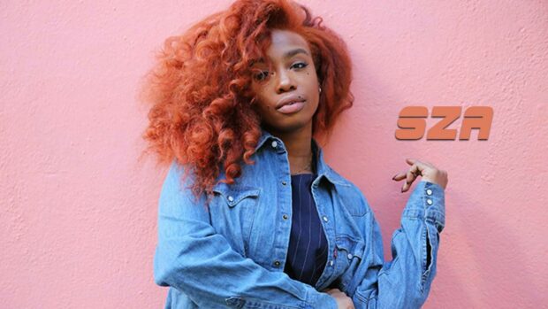 A confident woman with red curly hair wearing a denim jacket against a pink wall with Sza text