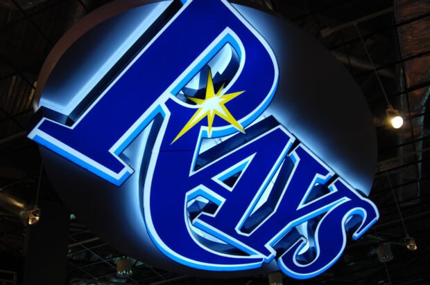 A glowing Tampa Bay Rays sign with blue letters and a yellow star design