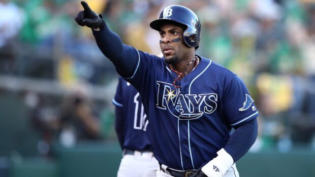 A Tampa Bay Rays player wearing a helmet and uniform pointing during a baseball game