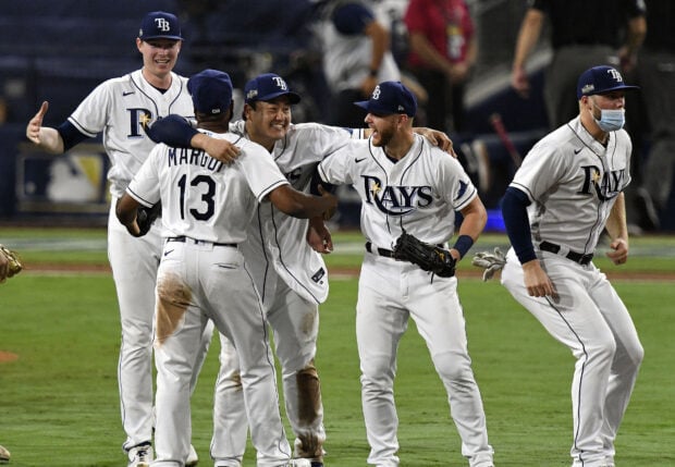 Tampa Bay Rays players celebrating on the field in Tampa Bay Rays uniforms