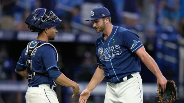 Tampa Bay Rays players congratulating each other after a play on the field