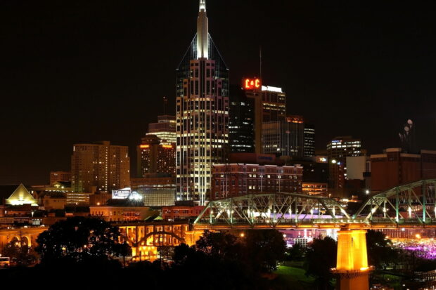 Night view of Tennessee city skyline with illuminated buildings and bridges