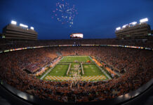 The Tennessee football stadium filled with fans during a nighttime game with fireworks in the sky