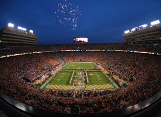The Tennessee football stadium filled with fans during a nighttime game with fireworks in the sky