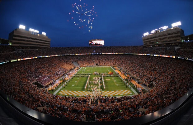 The Tennessee football stadium filled with fans during a nighttime game with fireworks in the sky