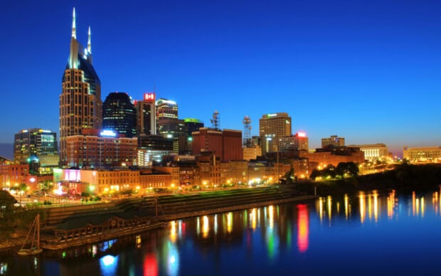 Nashville skyline at twilight showing Tennessee cityscape and river reflections
