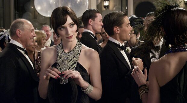 A woman in a black dress with intricate jewelry attending a Gatsby style party