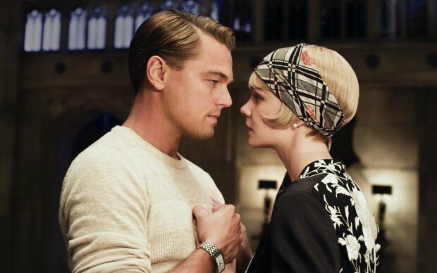 A romantic scene with Gatsby and Daisy facing each other closely in vintage style attire