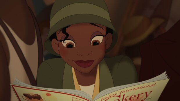 A young woman reading a magazine with a delighted expression on her face