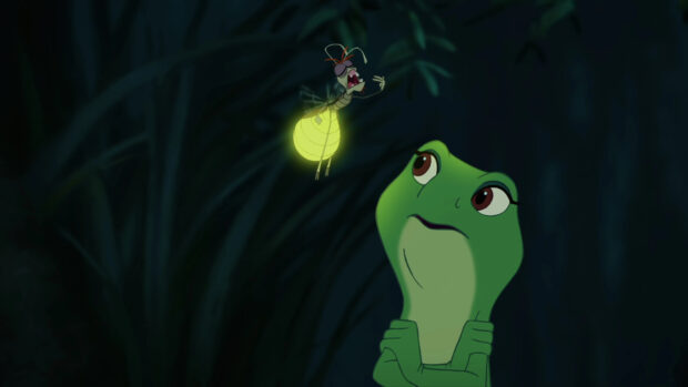 The frog character from the princess and the frog looks at the glowing firefly in the dark forest