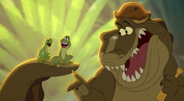 The princess and frog characters sitting on a hand with an alligator in the animated scene