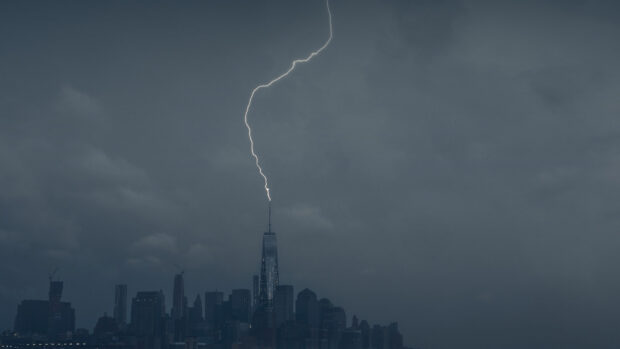 Lightning strike captured on city skyline with thunder during storm at dusk
