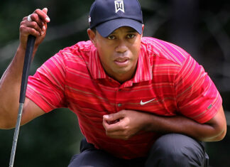 Tiger Woods concentrating on his golf putt during a tournament