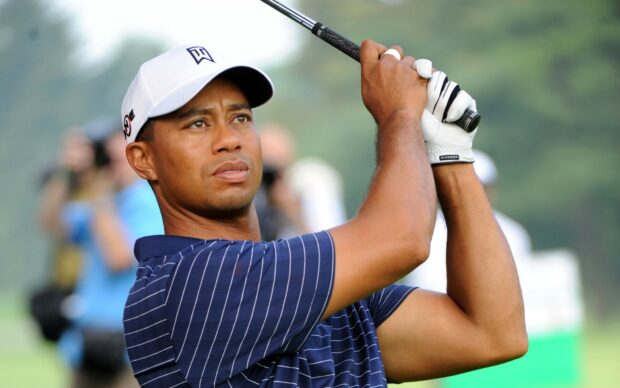 Tiger Woods focused on his golf swing in a professional tournament