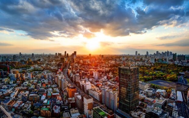 A stunning view of Tokyo Japan cityscape at sunset with vibrant colors and dramatic clouds