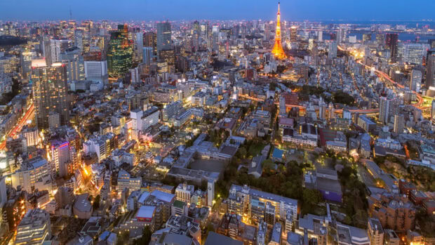 Aerial view of Tokyo Japan cityscape with illuminated buildings and Tokyo Tower at dusk