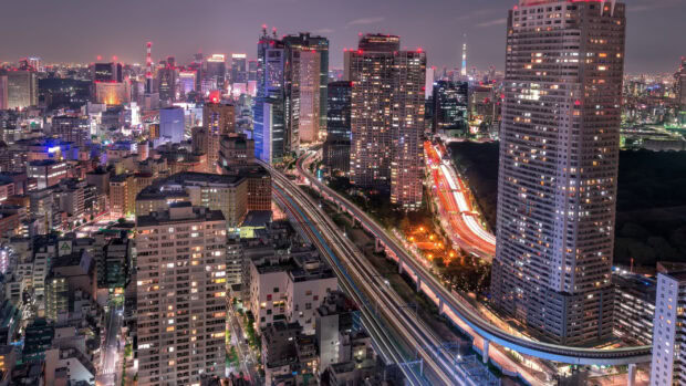 Night view of Tokyo cityscape with illuminated buildings and highways in Japan