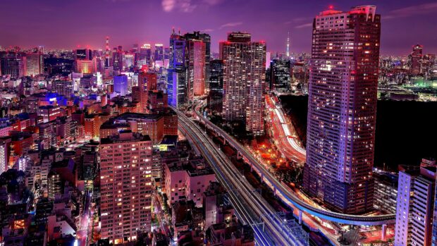 A vibrant cityscape of Tokyo Japan with illuminated skyscrapers and busy roads at night