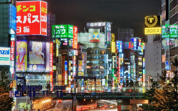 A vibrant cityscape of Tokyo Japan filled with colorful illuminated signs at night