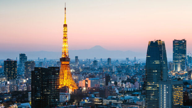 Tokyo Japan cityscape with Tokyo Tower illuminated at dusk and Mount Fuji in the background